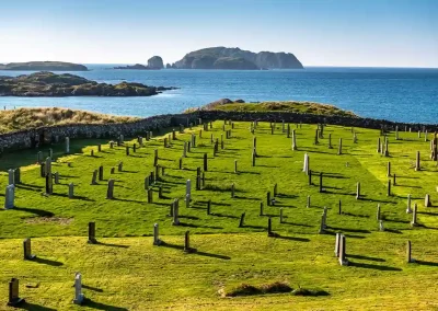 Historic cemetery overlooking blue Atlantic waters and rocky islands near Bosta Beach on the Isle of Lewis.