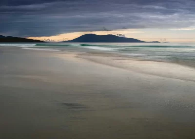 White sands and turquoise waves at Luskentyre Beach overlooking Taransay in South Harris, Scotland.