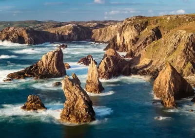 Mangersta sea stacks rising from turquoise Atlantic waters along the rugged west coast of Lewis, Scotland.