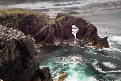Dramatic sea arch and rocky cliffs at Stac a’ Phris on the Atlantic coast of Lewis, Scotland.