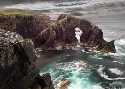 Dramatic sea arch and rocky cliffs at Stac a’ Phris on the Atlantic coast of Lewis, Scotland.
