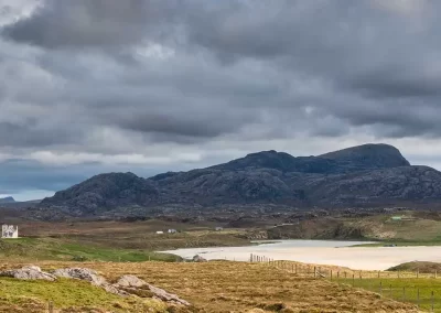 White sands, croftland and rugged mountains surrounding Uig Bay on the Isle of Lewis, Scotland.