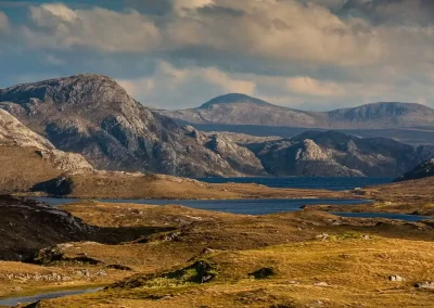 Rocky mountains, moorland and freshwater lochs across the wild landscape of the Isle of Lewis, Scotland.
